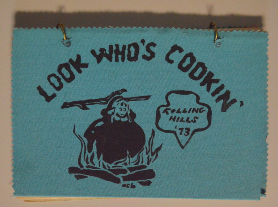 Screen printed cover of a 1973 Rolling Hills Girl Scout Council cookbook entitled "Look Who's Cooking"