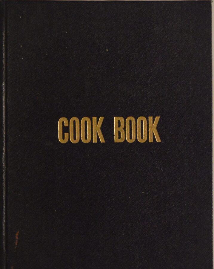 Black cover of a cookbook that simply treads "Cook Book"