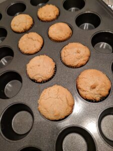 Eight mini cupcakes in cupcake tin.